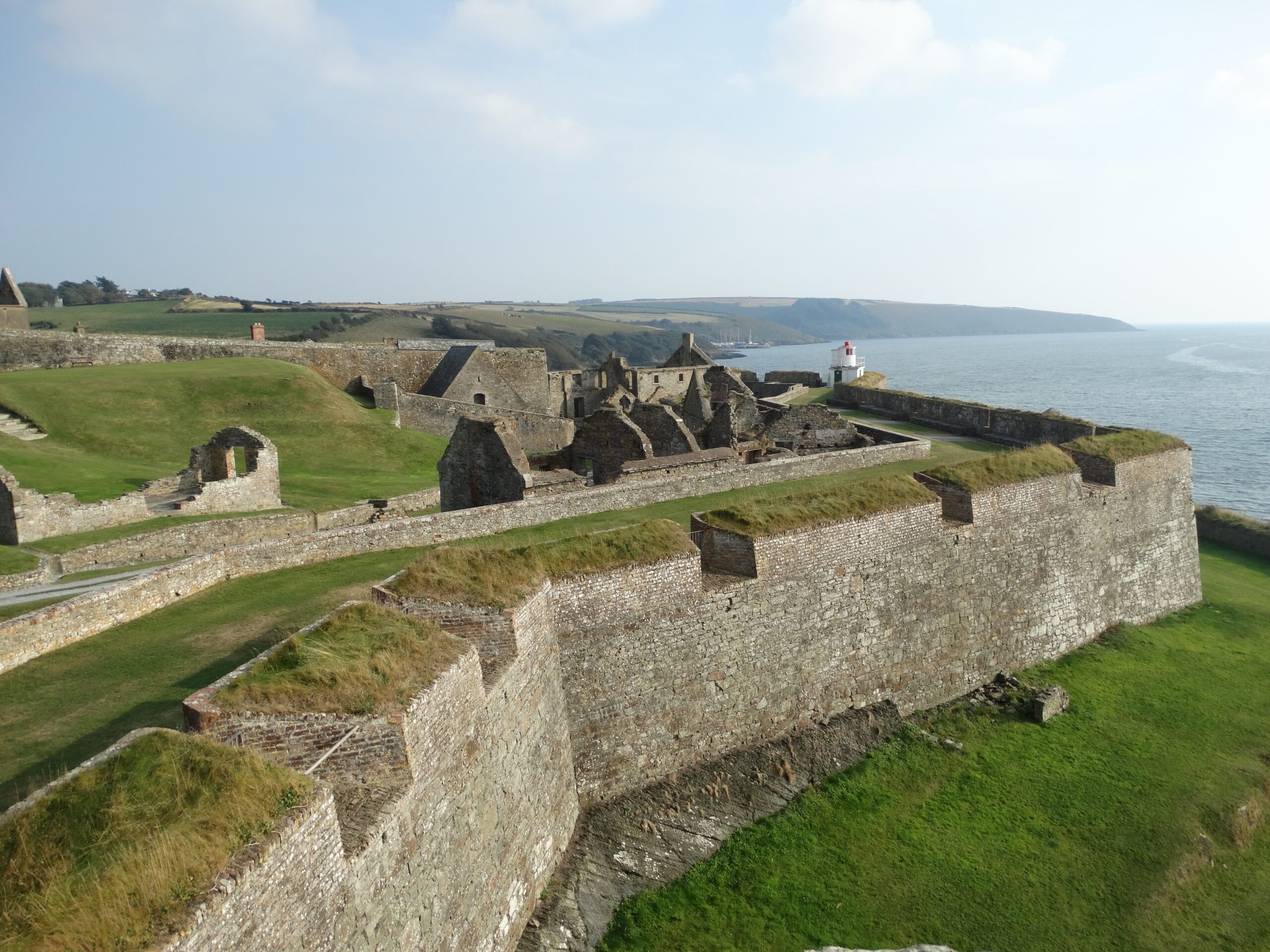 historic stone fortress with grassy surroundings overlooking a stunning coastline