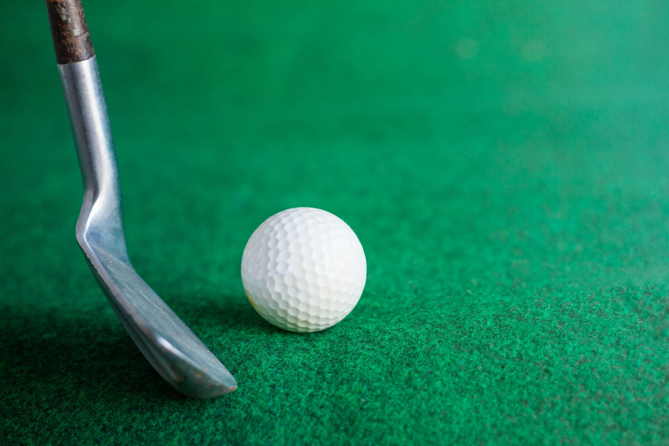 On a Dublin green, a putter rests beside a golf ball, ready for action.